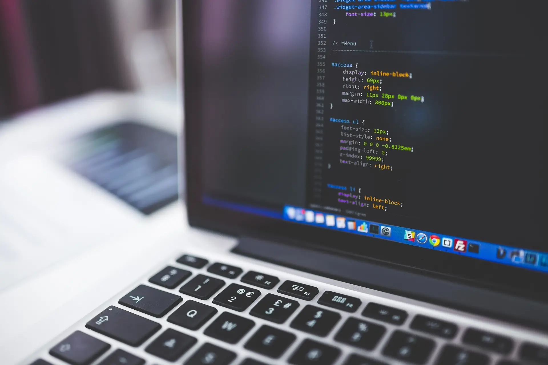 A laptop showing code in a text editor